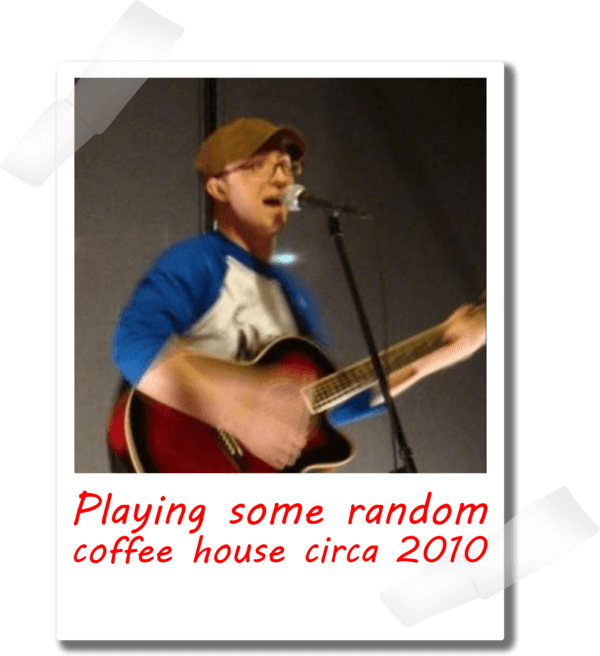 Phil playing guitar at a coffee house circa 2010